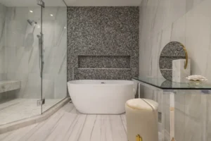 Luxury primary bathroom in Miami featuring sensory hydrotherapy, integrated circadian lighting, and natural stone finishes by Sarah Z Designs