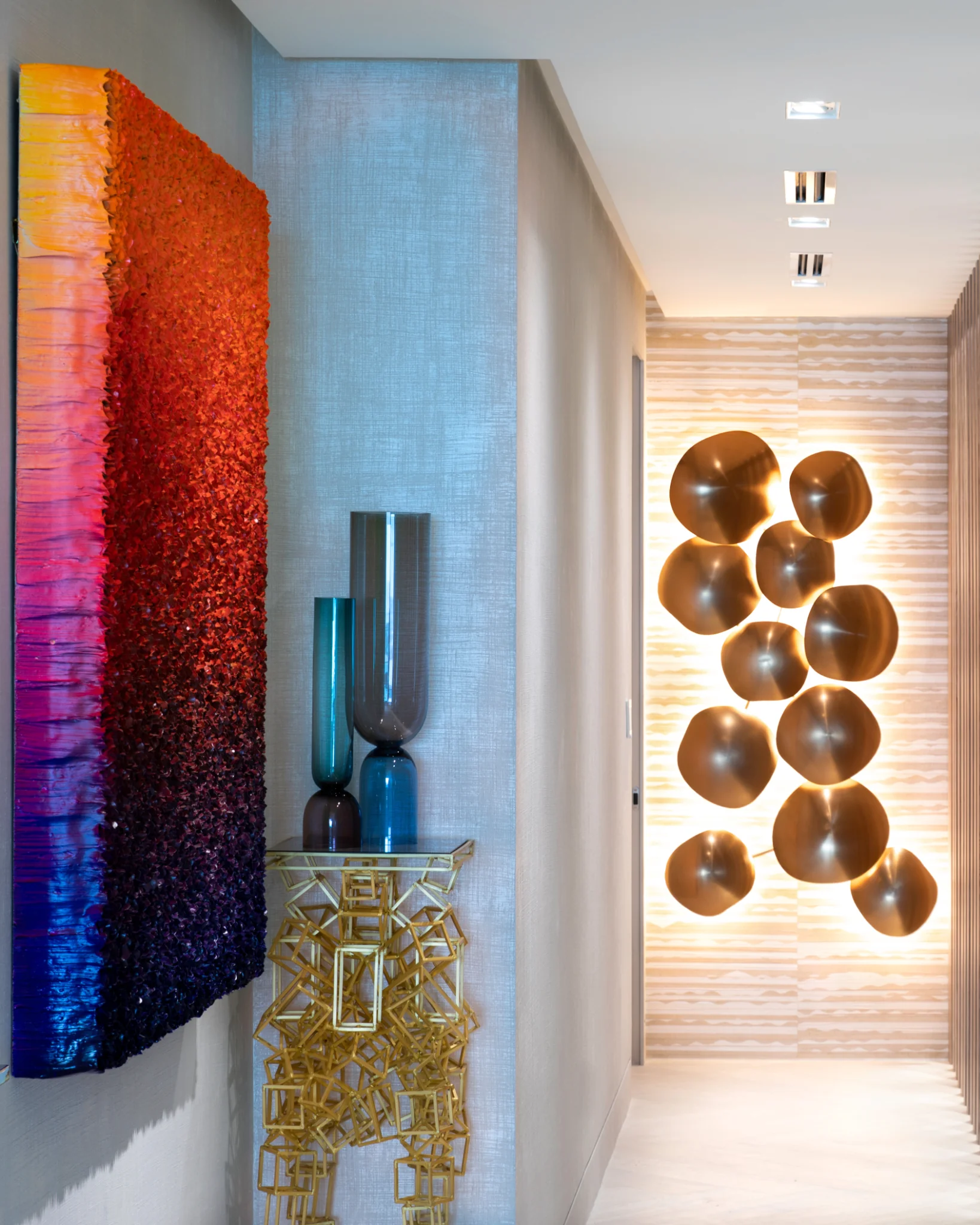 Art, natural texture and layered architectural lighting create organic movement and sensory depth in a Bal Harbour biophilic interior designed by Sarah Z Designs.