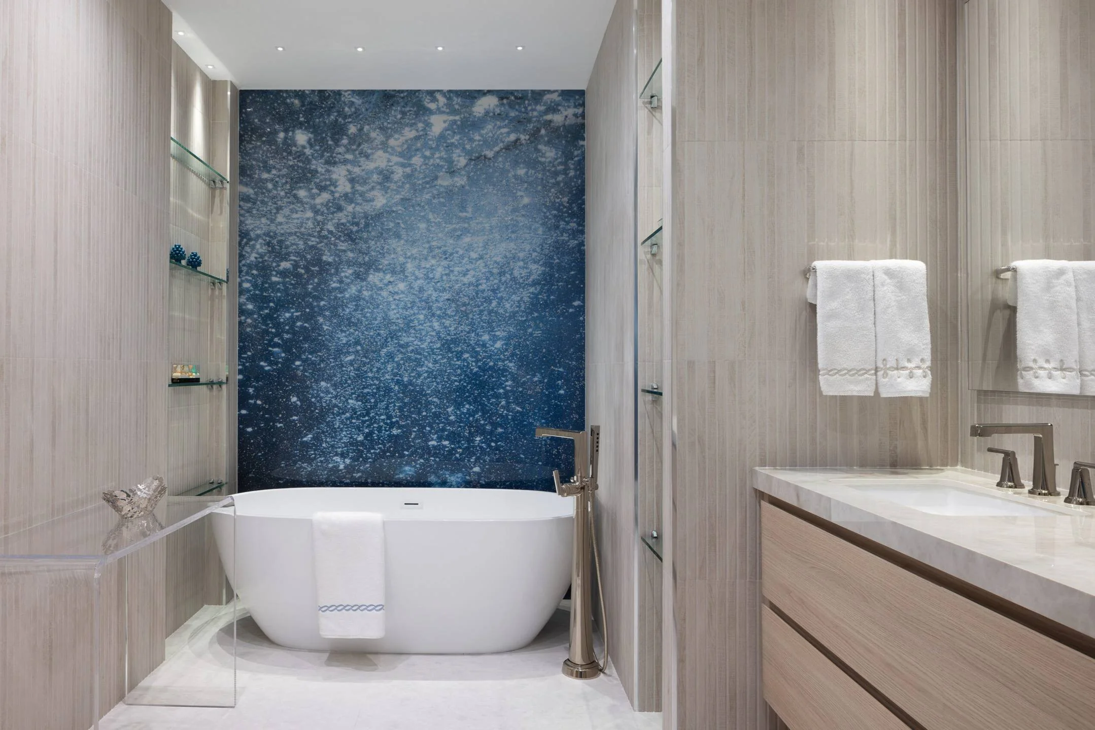 Honed stone and quiet texture define the primary bath as a grounding retreat in this Miami estate.