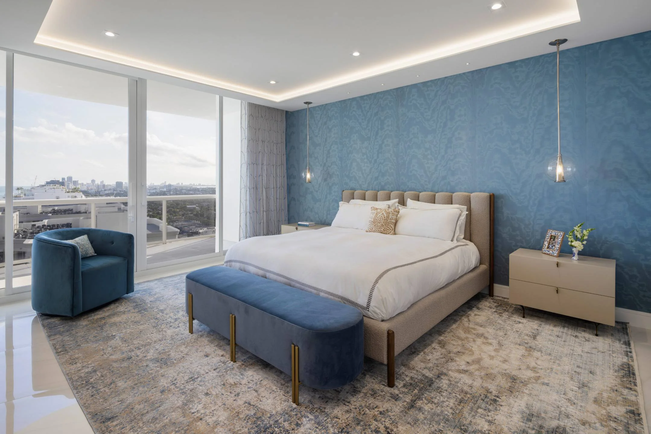 Soft texture and quiet color layer this Brickell primary suite — warmth in spirit, cool in temperature.