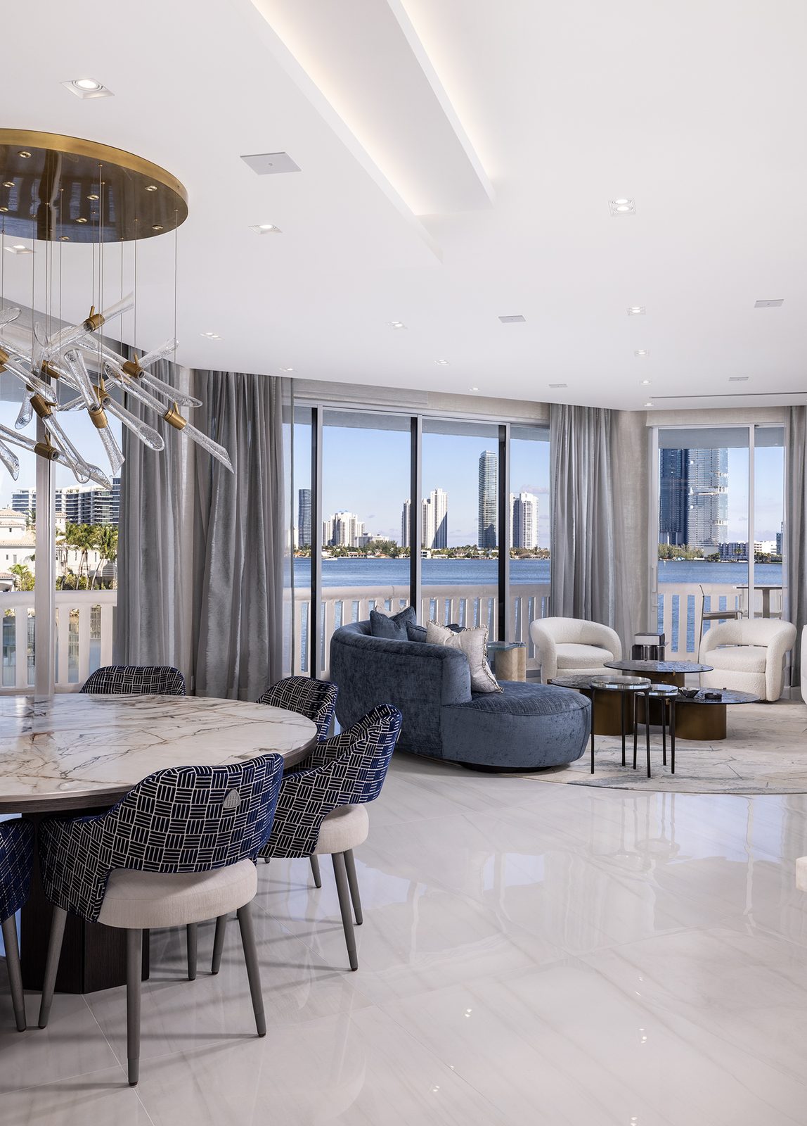 The dining table sits in line with the glass, keeping the water in view throughout the meal.
