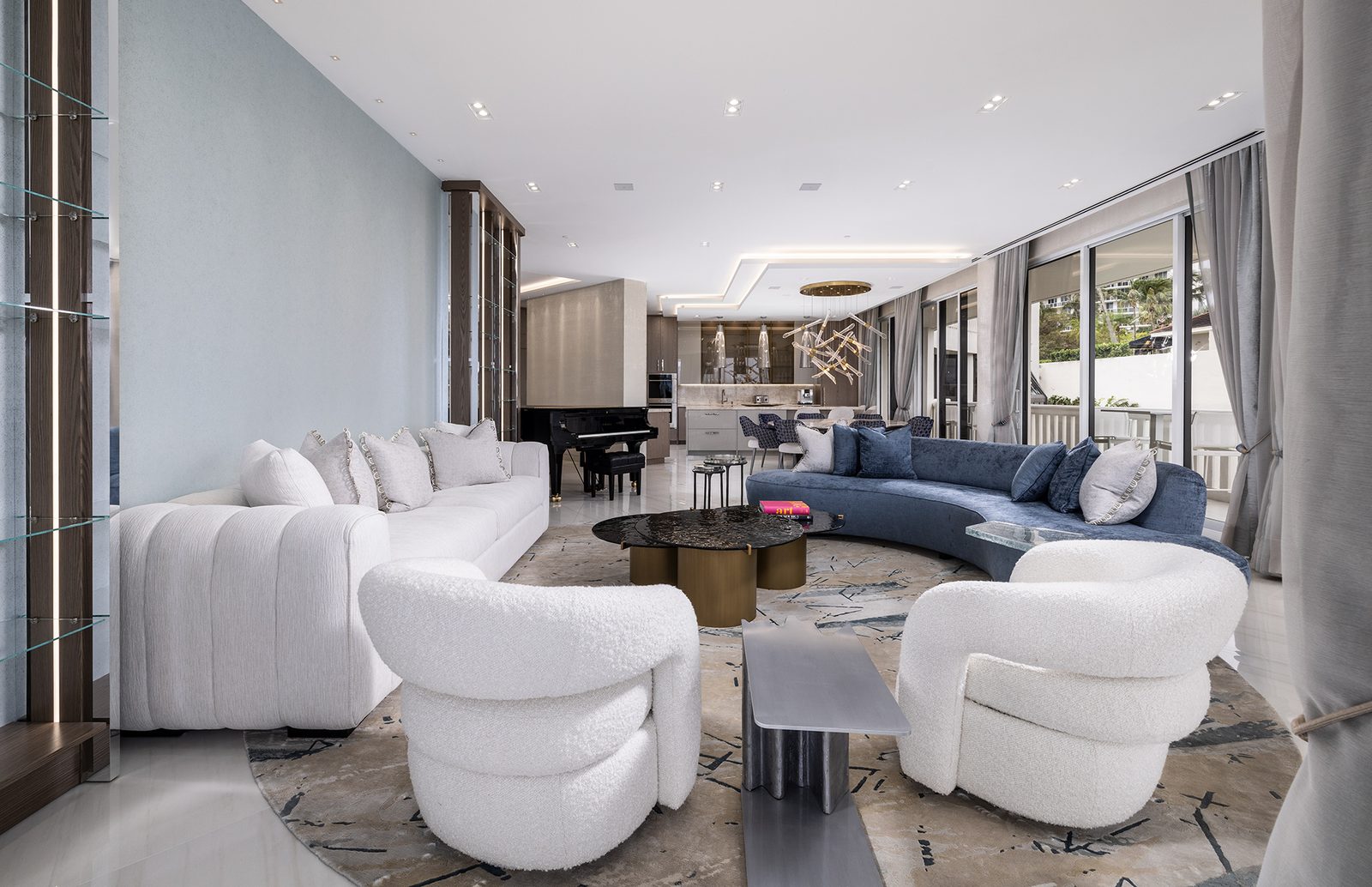 An open sightline runs from the living room past the piano to the kitchen.