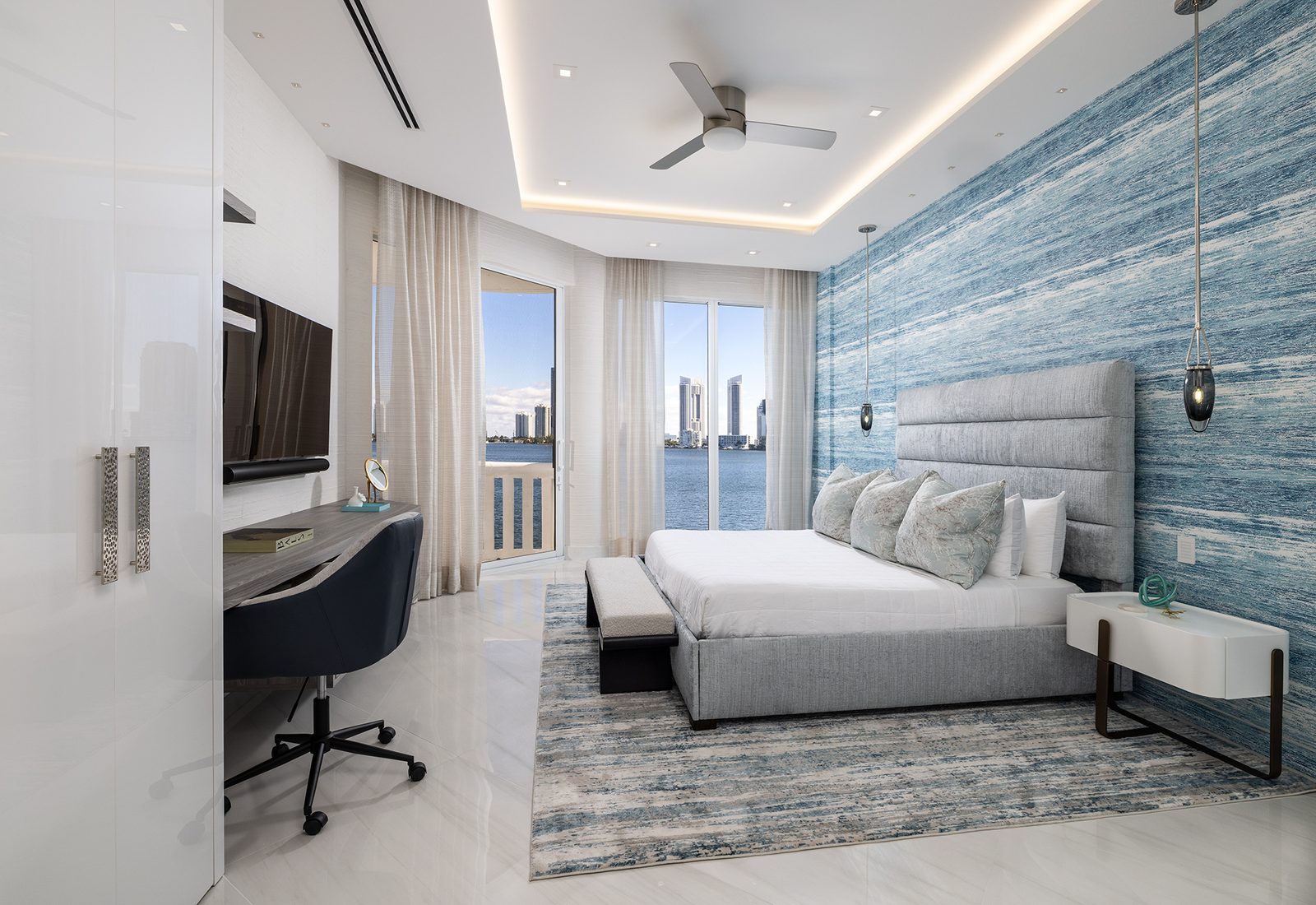 Sheer drapery and open terrace doors let breeze and shifting light move through the bedroom.